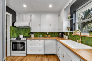 Small Kitchen Renovation - After - Upgraded Floor, counter tops, appliances, backsplash, and gave the current cabinets a facelift