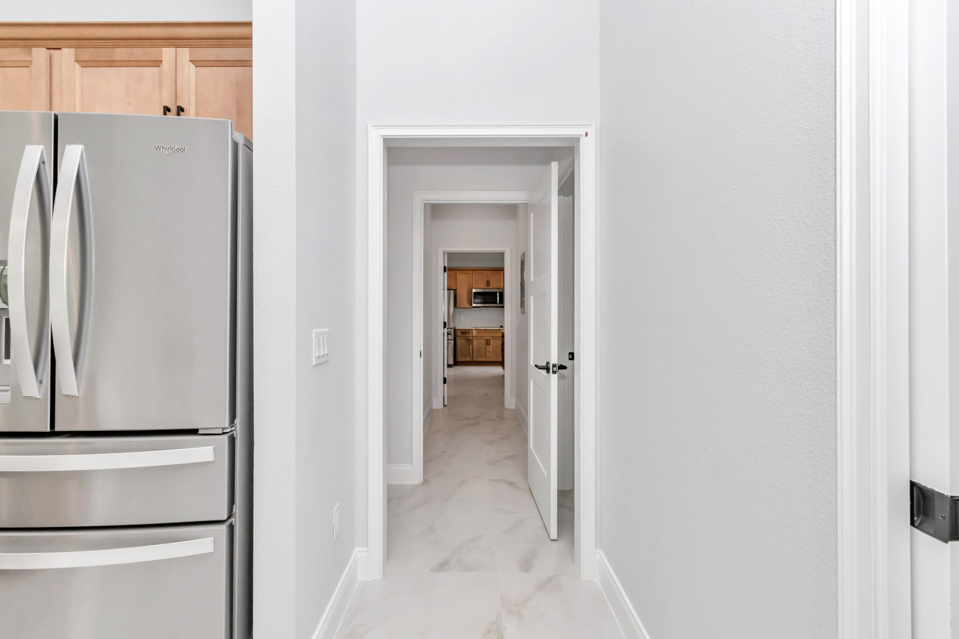 Flexible hallway design in the French Residence, allowing connection or separation of living areas, a smart Ocala home design with mother-in-law suite.