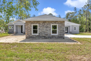 garage window view of the French Residence, a versatile custom home built by Ocala home builders.