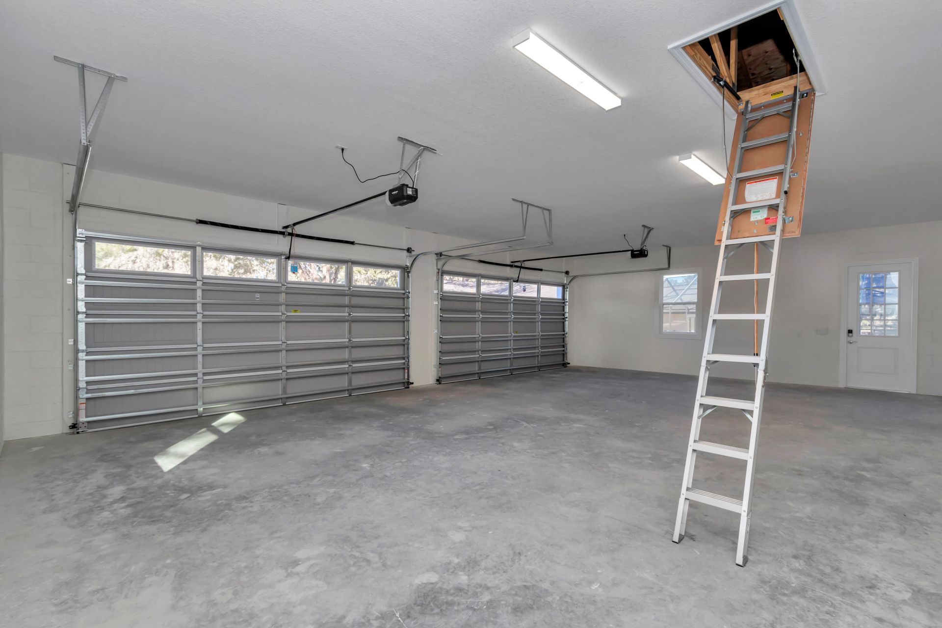Attic access area leading to a spacious, unfinished upper-level storage space.