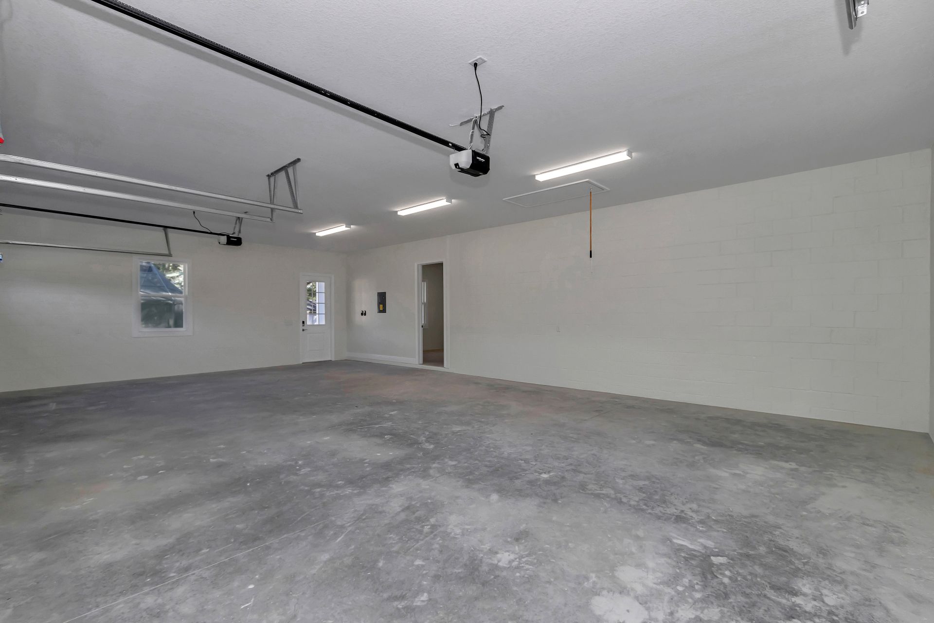 Empty two-car garage interior showcasing the level concrete and high-quality framing.