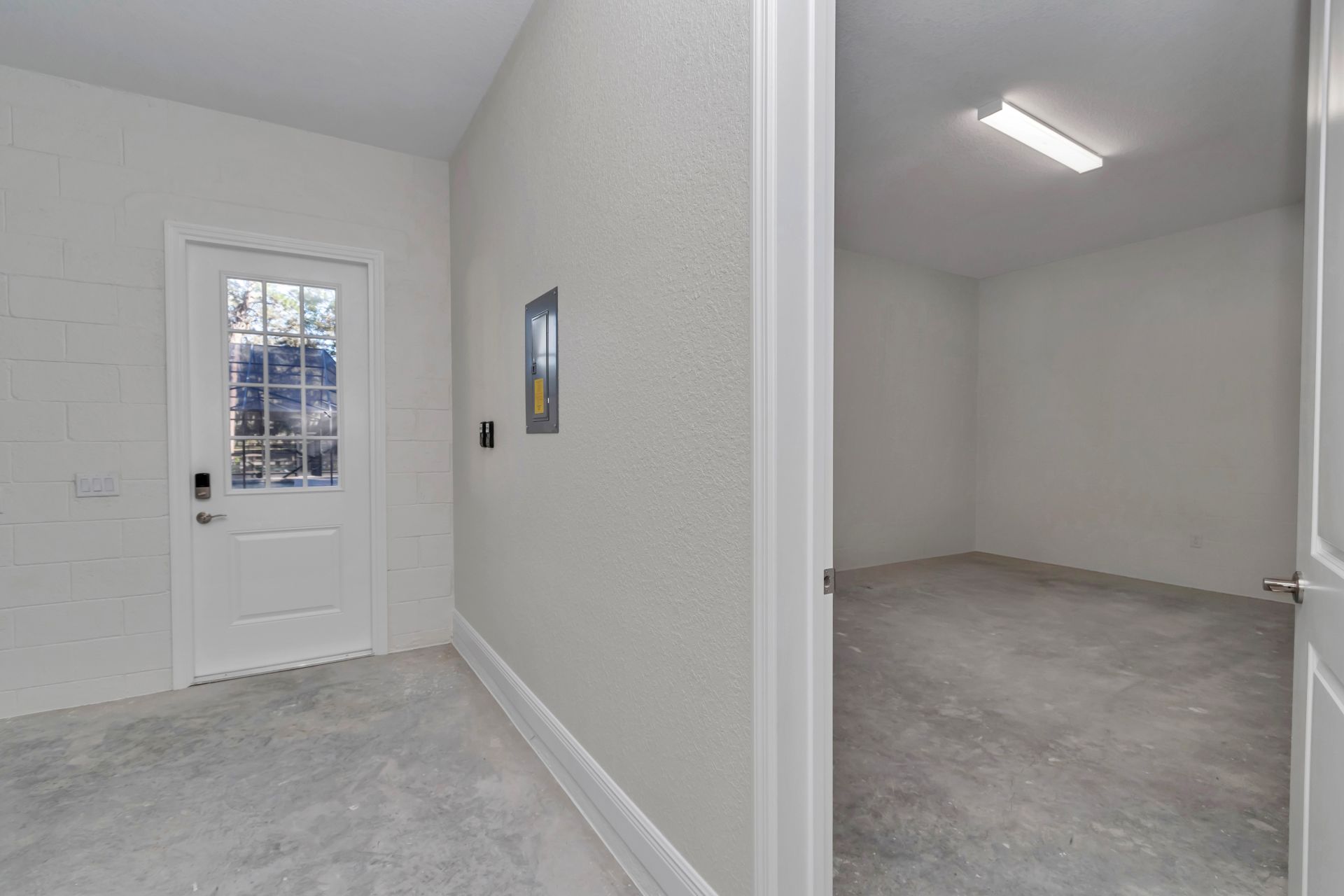 Interior foyer with the private office door to the left and garage access to the right.