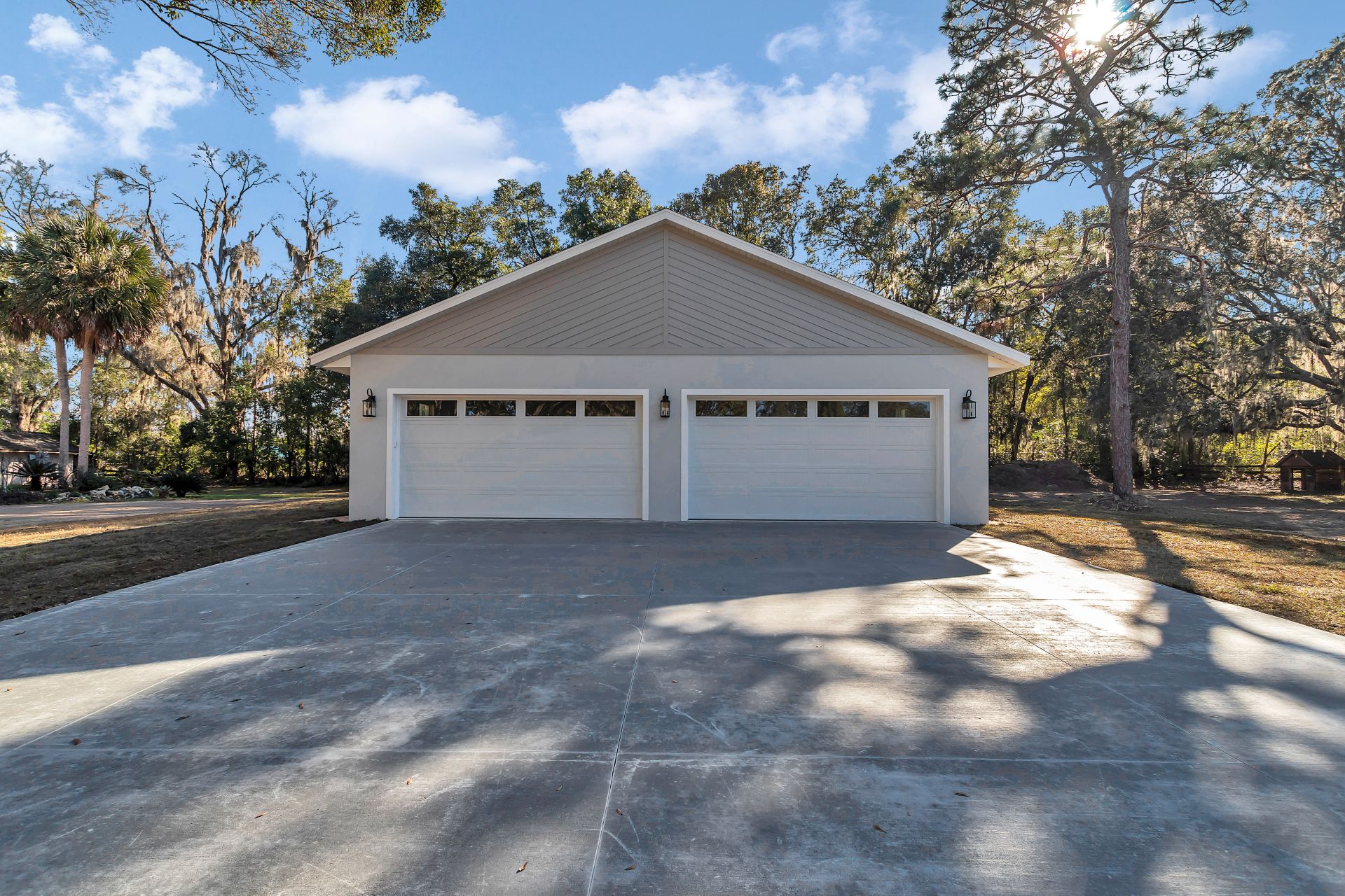 Symmetry shot of a new construction detached garage showing two overhead doors.