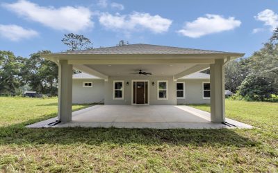 A view of the home's front entry and unique covered porte-cochère