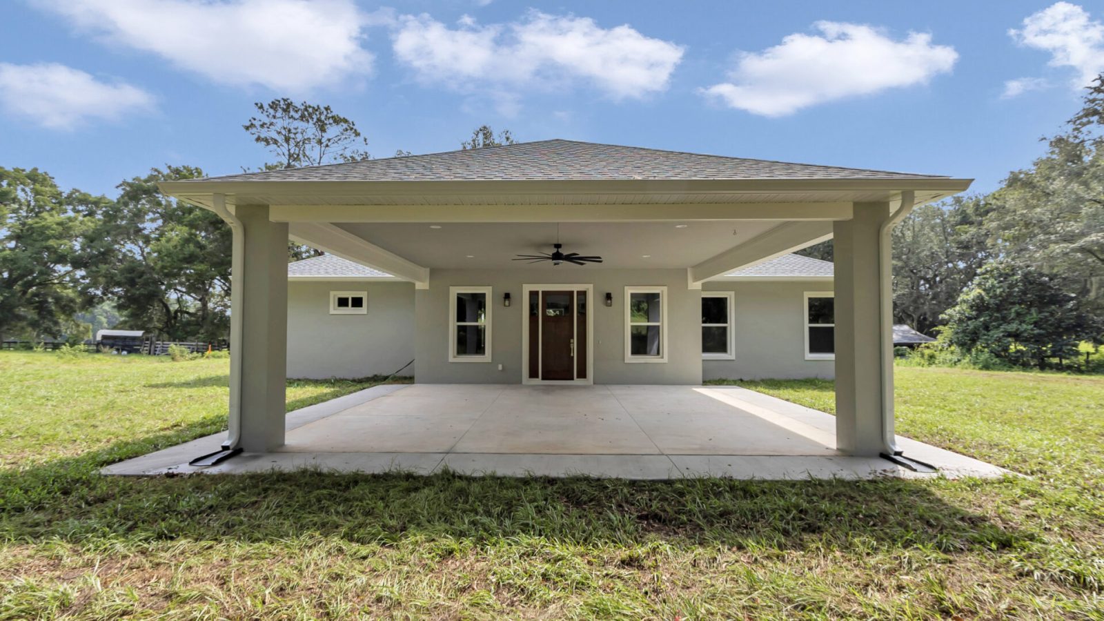 A view of the home's front entry and unique covered porte-cochère