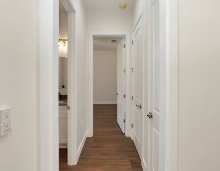 A view of the secondary guest wing featuring a common bathroom, bedroom entrance, and built-in storage solutions.