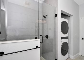 Bathroom with walk-in shower and laundry hookups in the independent living quarters of the French Residence3