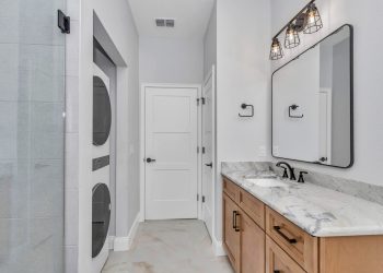 Bathroom with walk-in shower and laundry hookups in the independent living quarters of the French Residence4
