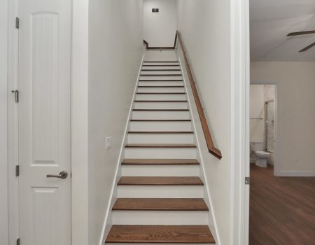 Close-up of the durable tile steps and white-painted risers, showcasing the high-end carpentry in the Fort McCoy home
