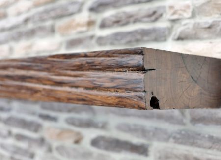 Detailed view of the real wood mantle and stone ledge, perfectly paired with the home's wood-look tile floors.