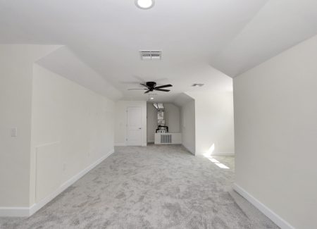 Discreet air handler closet located within the finished attic for easy maintenance and climate control.