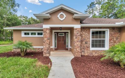 Entrance detail featuring custom fieldstone wainscoting and cherry wood door in Ocala.