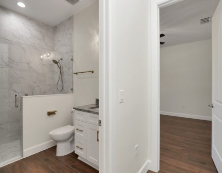 Entryway to the home's fourth bathroom, positioned off the great room for easy access by guests and family.