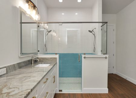 Luxury master bathroom featuring a custom-tiled walk-in shower and double vanity, a signature of this custom home builder in Ocala, FL.