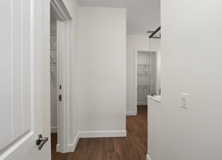 First look inside the expansive master bathroom, featuring a large walk-in closet to the left and a custom shower to the right.