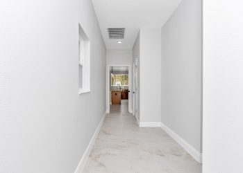 Functional mudroom with hidden pantry and direct garage access, designed by Ocala home builders for the French Residence.