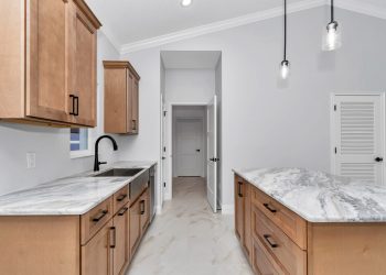 Independent kitchen with granite counters and cathedral ceilings, part of the mother-in-law suite design in Ocala's French Residence 3