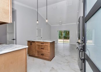 Independent kitchen with granite counters and cathedral ceilings, part of the mother-in-law suite design in Ocala's French Residence 4