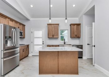 Independent kitchen with granite counters and cathedral ceilings, part of the mother-in-law suite design in Ocala's French Residence 5
