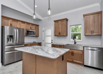 Independent kitchen with granite counters and cathedral ceilings, part of the mother-in-law suite design in Ocala's French Residence 6