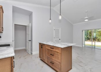 Independent kitchen with granite counters and cathedral ceilings, part of the mother-in-law suite design in Ocala's French Residence5