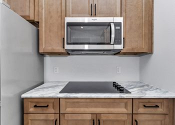Independent kitchen with microwave and counter top range, part of the mother-in-law suite design in Ocala's French Residence.