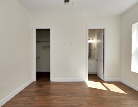 Private guest suite with an en-suite bathroom and walk-in closet, showcasing the functional floor plans offered by this custom home builder in Ocala, FL.