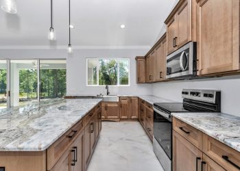 Kitchen featuring large island and ample counter space - home designs with mother in law suites