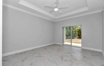 Luxurious master bedroom with trey ceilings and crown molding in the French Residence, built by Ocala home builders - home designs with mother in law suites