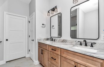 Master bathroom with double granite vanity - home designs with mother in law suites