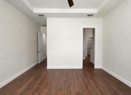 Perspective from the master bedroom looking toward the entry door and the private entrance to the master bathroom.