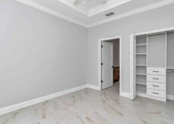 Private bedroom custom closet shelving in the mother-in-law suite of this custom Ocala home.
