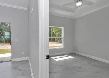 Private bedroom with trey ceiling in the mother-in-law suite of this custom Ocala home