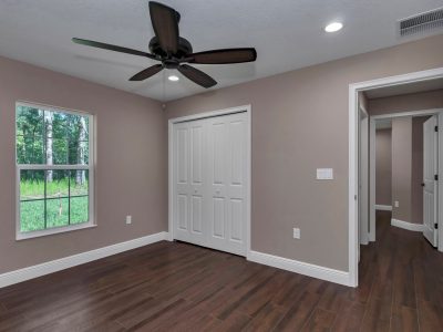 View of bedroom two highlighting the spacious closet and bright, inviting aesthetic