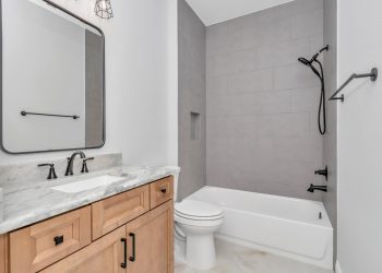 bathroom 2 has matching granite counter tops with tub
